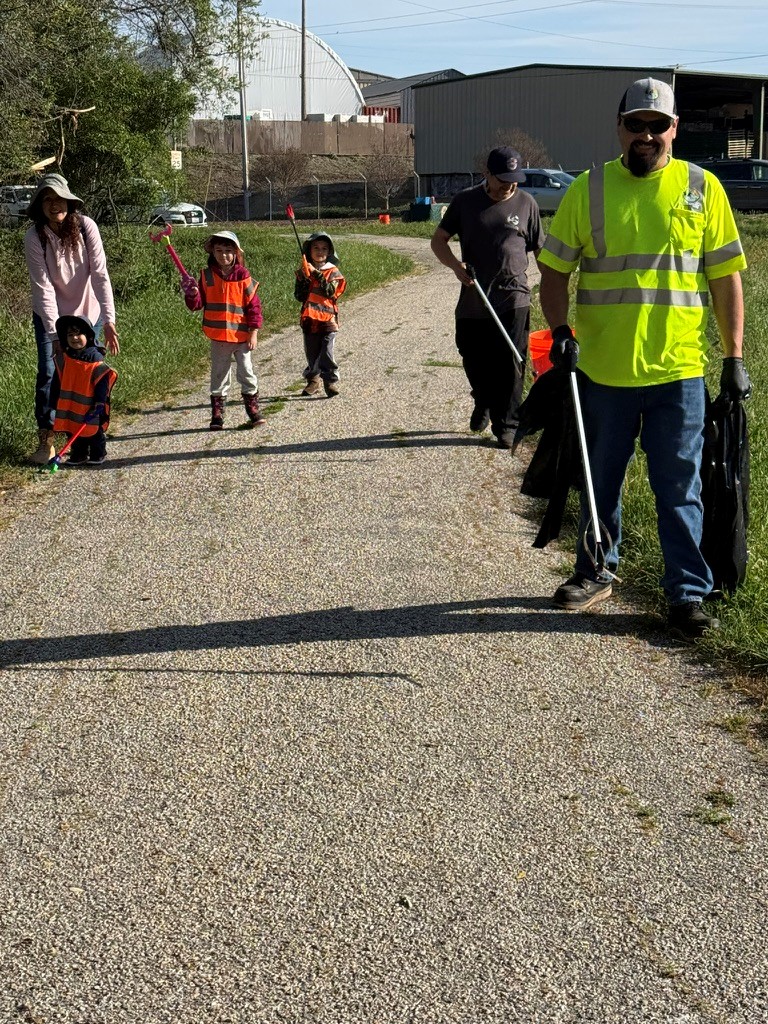 A family is cleaning up the trail